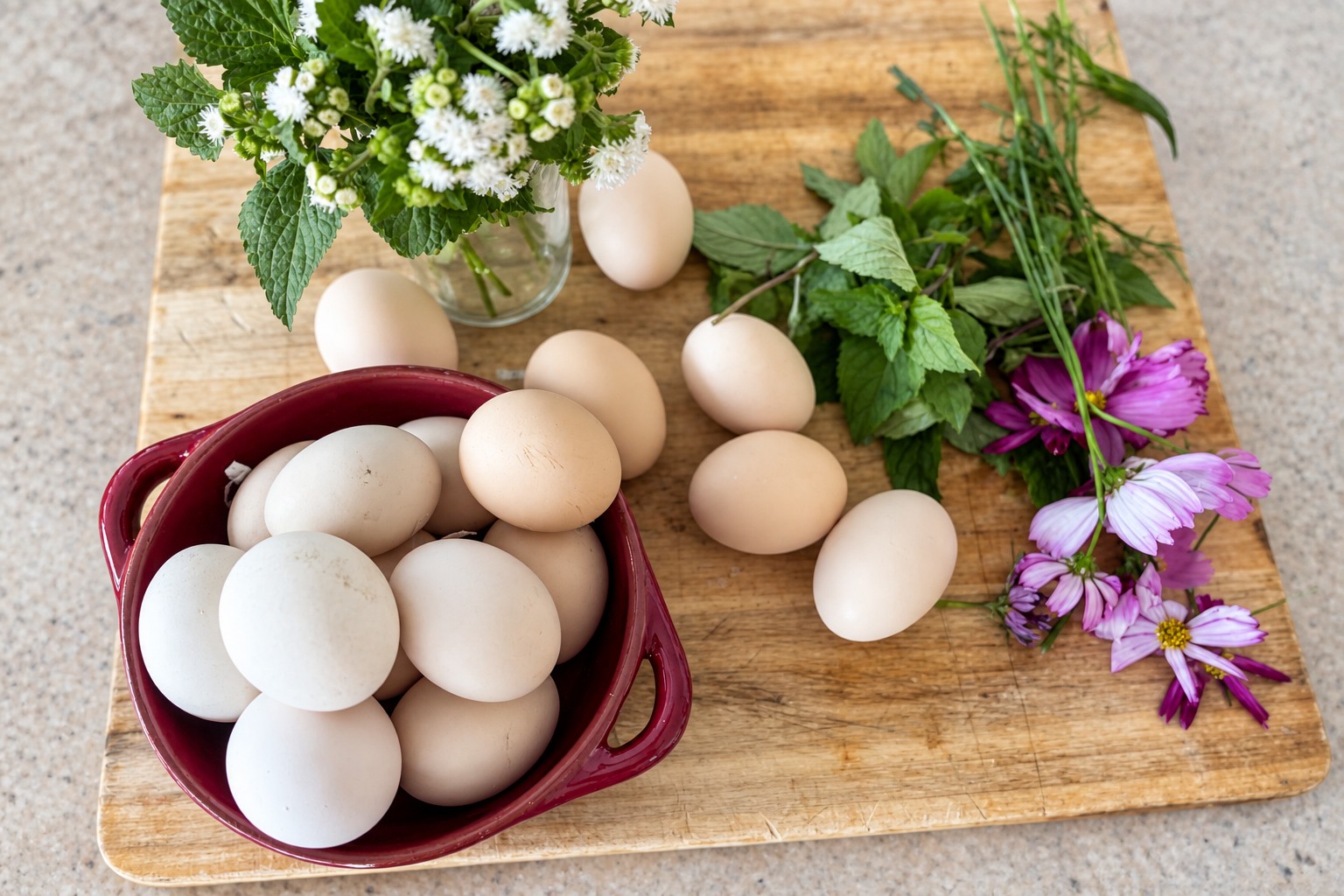 The Barnettis’ farm eggs, garden flowers and basil arranged on a timber board